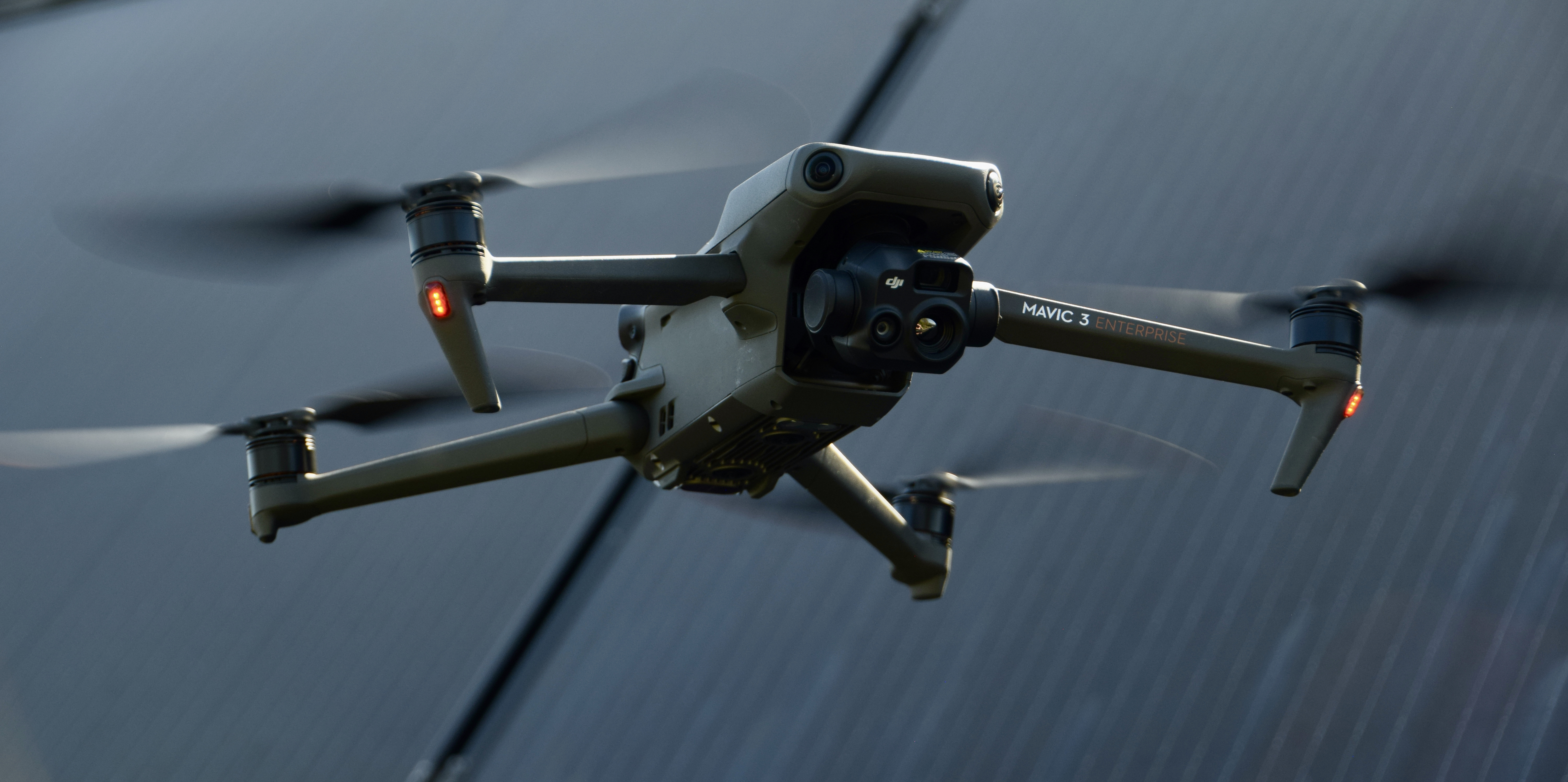 Drone hovering over solar panel